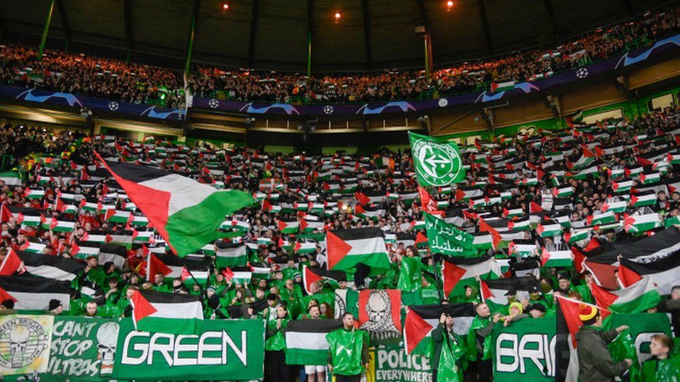 Celtic Glasgow's supporters waving the palestinian flag and wearing the palestine football shirt