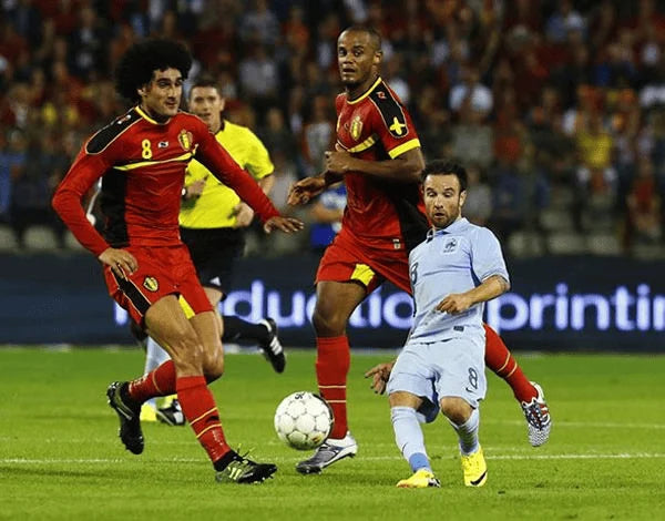 Valbuena, a football player for france next to Fellaini and company from belgium