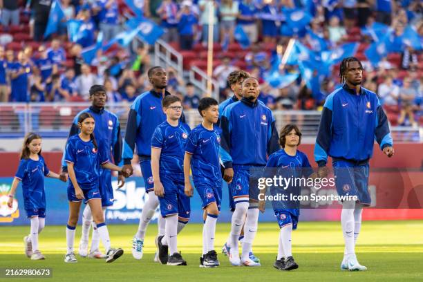 chelsea men's soccer team walking out with kids