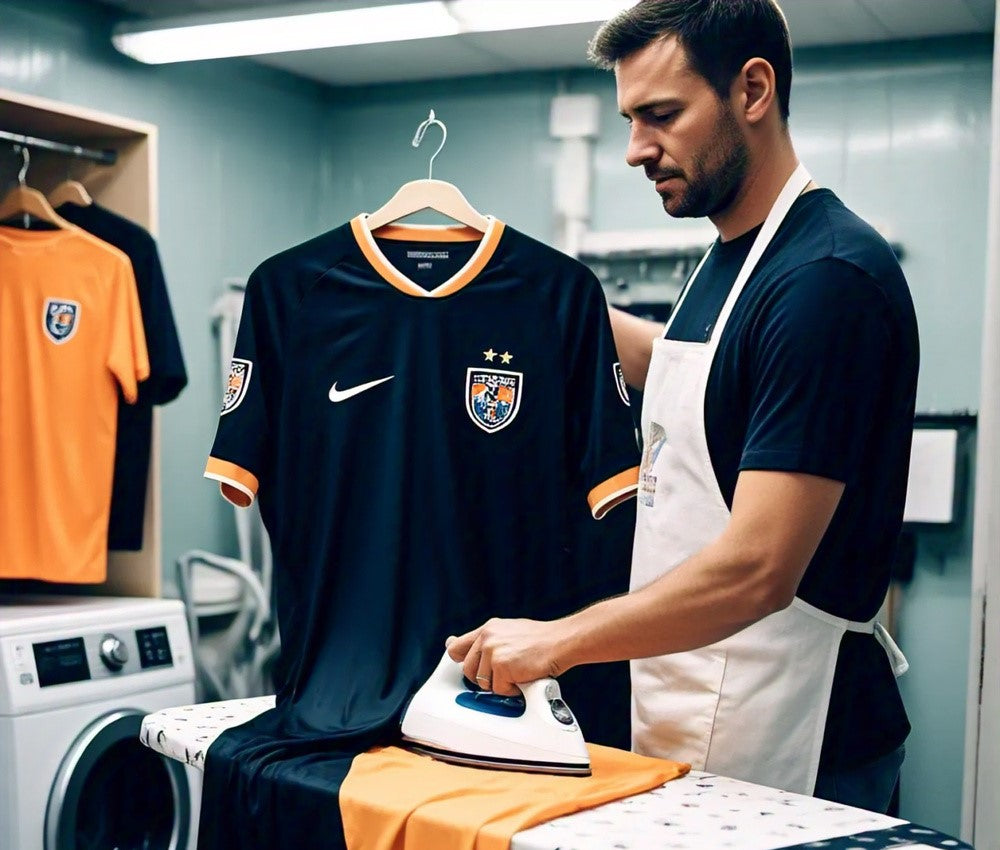 a man ironing his football shirts