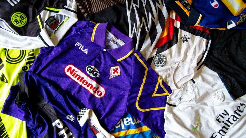 a pile of retro football shirts - retro football jerseys