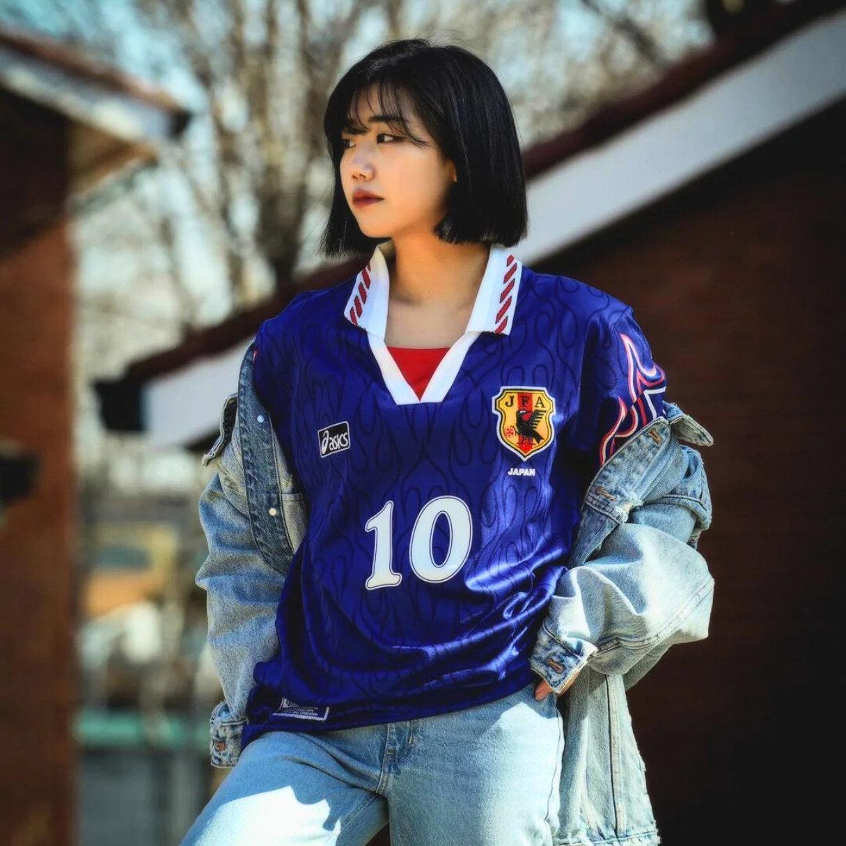 a woman wearing 1998 japan world cup soccer jersey